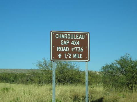 1968 Ford Mustang - A brown sign indicates the direction and distance to Charouleau Gap 4x4 Road #736.