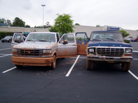 1978 Ford Bronco - A blue 1978 Ford F-Series truck, covered in mud, is parked next to another muddy vehicle.