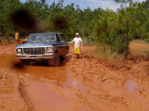 1978 Ford Bronco - 1978 Ford Bronco navigating a muddy off-road trail.