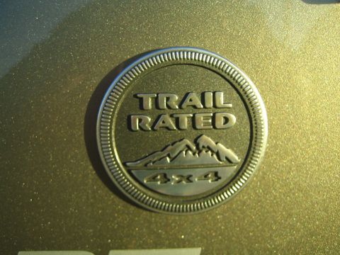 1968 Ford Mustang - A close-up of a Trail Rated 4x4 badge on a gold vehicle's exterior.
