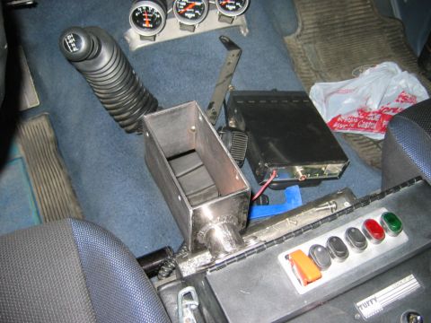 1985 Ford Bronco - Custom shifter console with CB radio and auxiliary switches installed in a vehicle interior.