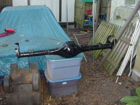 1989 Ford Bronco - Rear axle assembly is the main subject, shown outdoors on storage bins.