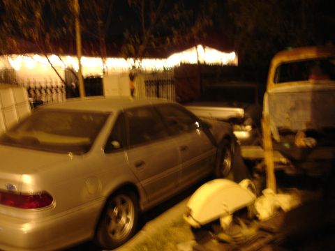 1992 Ford Taurus - A silver 1992 Ford Taurus sedan is parked outdoors at night, with another vehicle visible in the background.