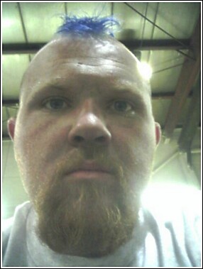 1979 Ford Bronco - A man with a blue mohawk and beard is shown in this close-up photo.