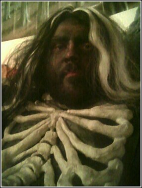 1979 Ford Bronco - A person in a skeleton costume and wig is shown, with a Supermotors logo visible.