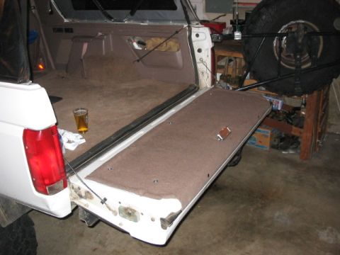 1995 Ford Bronco - Used 5 screws to secure the carpet and access panel to the tailgate. remove these, and you have access inside the tailgate.