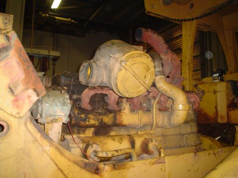 1966 International School Bus - This is a close-up view of a large engine, likely from heavy machinery, showing its air intake and exhaust systems.