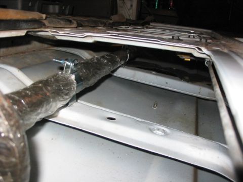 1995 Ford Bronco - Interior view of a vehicle's tailgate storage area, showing a wrapped bar secured with a clamp.