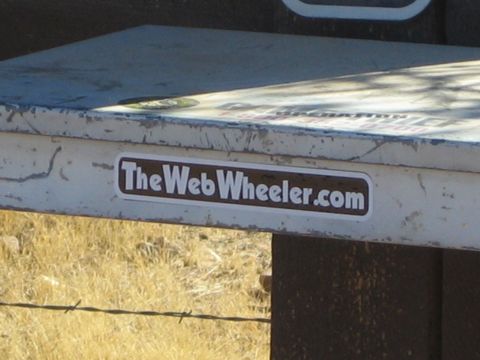 1968 Ford Mustang - A sticker with a website address is affixed to a weathered metal surface.
