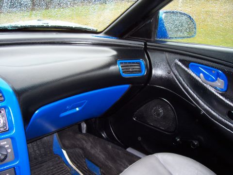 1993 Ford Probe - The interior of a 1993 Ford Probe features custom blue trim and a black dashboard.