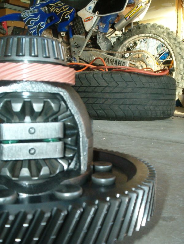 Differential gears with a dirt bike in the background