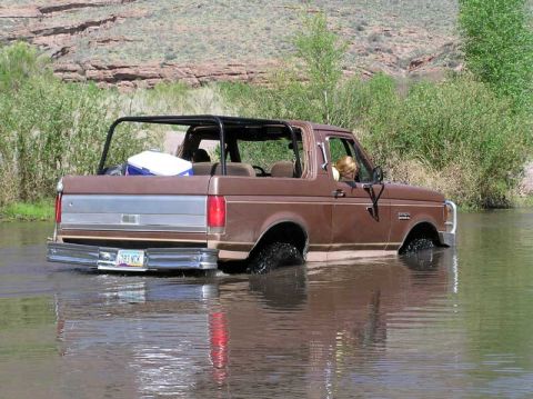 1989 Ford Bronco - This 1989 Ford Bronco is shown navigating a shallow river with its top removed.