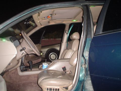 1993 Ford Taurus - The interior of a car is shown at night, with a second vehicle visible in the background through the window.