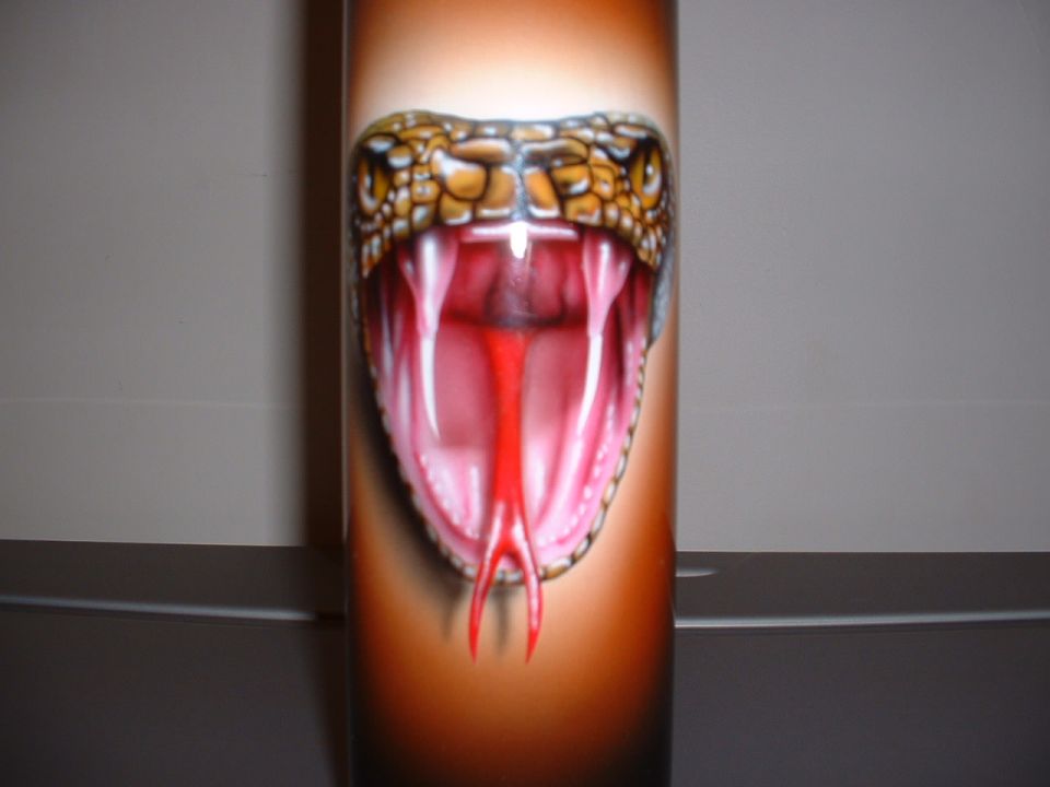 Airbrushed snake head with fangs and red tongue