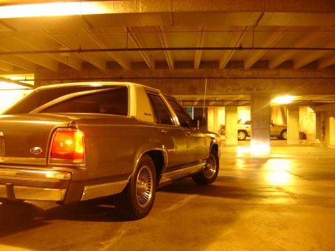 1988 Ford Crown Victoria LTD - Rear view of a 1988 Ford Crown Victoria LTD in a parking garage at night.