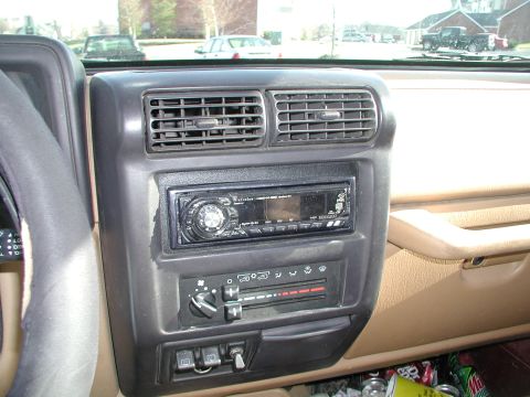 1998 Jeep TJ - Interior view of a Jeep TJ dashboard, showing the center console with radio and HVAC controls.