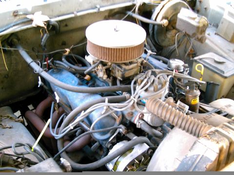 1986 Ford Bronco - Close-up view of a vehicle's engine bay, showing various engine components and wiring.