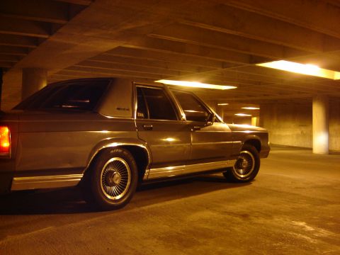 1988 Ford Crown Victoria LTD - Side view of a 1988 Ford Crown Victoria LTD in a dimly lit parking garage.
