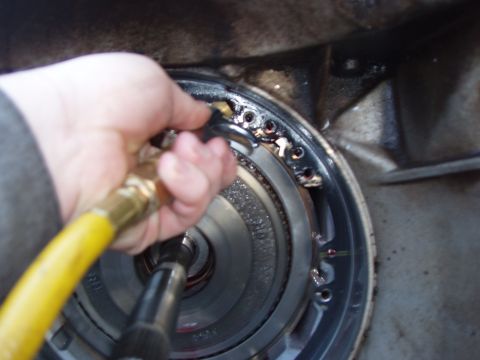 1995 Ford C-350 (Centurion Conversions) - Cleaning a transmission component, likely part of a shift kit installation.