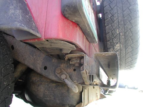 1998 Jeep TJ - This photo shows the rear undercarriage of a Jeep Wrangler, including the spare tire mount and bumper assembly.