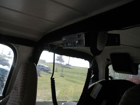 1998 Jeep TJ - Interior view of a vehicle showing a CB radio and microphone, with other vehicles visible through the windows.