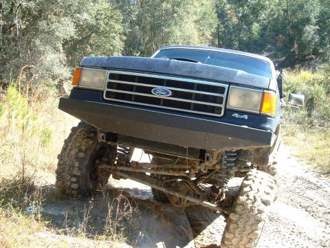 1995 Ford Bronco - This modified Ford Bronco navigates a challenging off-road path.