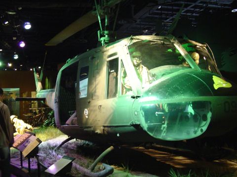 1994 Ford Bronco - A military helicopter is on display, possibly in a museum, with a mannequin pilot in the cockpit.