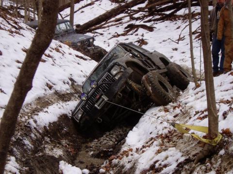 1992 Ford Bronco - Off-road vehicles stuck in a ditch during winter conditions.
