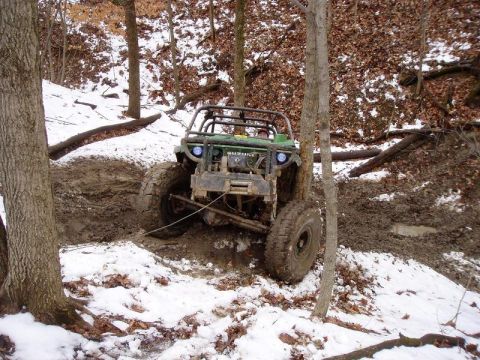 1992 Ford Bronco - This modified off-road vehicle tackles a challenging muddy and snowy trail, its capabilities.