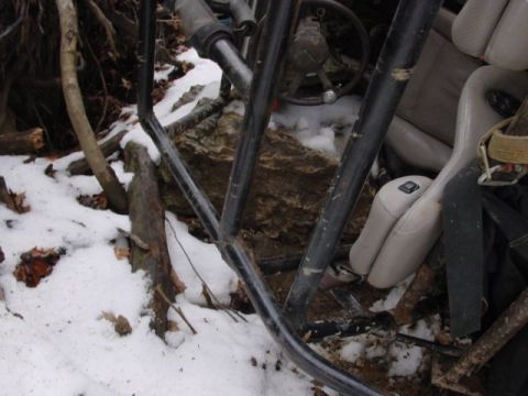 1992 Ford Bronco - The interior of a 1992 Ford Bronco is seen with a roll cage and tan seats, partially covered in snow.