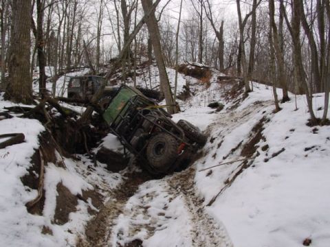 1992 Ford Bronco - These off-road vehicles appear to be stuck in a snowy, wooded area after an apparent mishap.