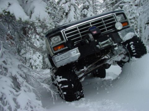 1986 Ford Bronco - This 1986 Ford Bronco navigates a snowy forest trail, its off-road capabilities with a winch mounted on the front.