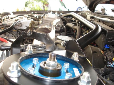 1989 Mazda MX-6 - This image shows a detailed view of a vehicle's engine compartment, highlighting the suspension and various engine parts.