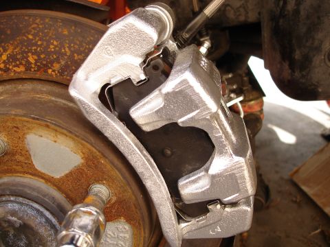 1989 Mazda MX-6 - Brake caliper and rotor detail, showing wear on the rotor.