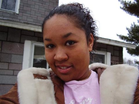1997 Ford Taurus - A woman poses for a selfie in front of a house with a brick exterior.