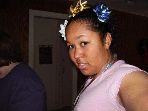1997 Ford Taurus - A woman with gift bows in her hair looks towards the camera.