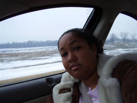 1997 Ford Taurus - A woman is seen from inside a 1997 Ford Taurus, looking out at a snowy, overcast day.