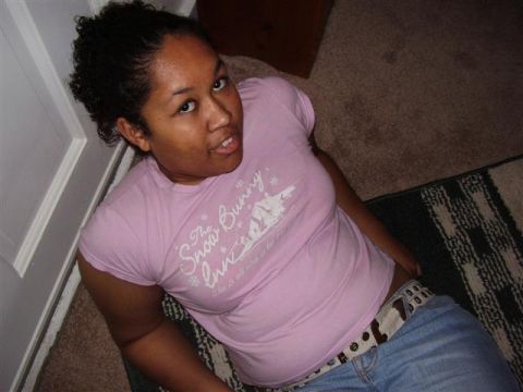 1997 Ford Taurus - Woman in a pink t-shirt and blue jeans sits on the floor.