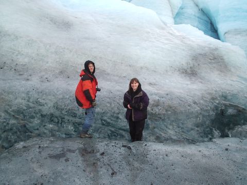 2000 Ford E350 - Two individuals pose for a photo on a glacier, surrounded by ice and snow.