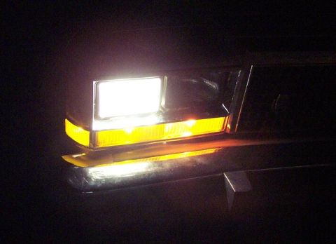 1985 Ford LTD Crown Victoria - Close-up of a vehicle's front lighting assembly, showing the headlight and turn signal.