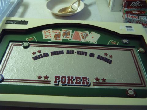 1988 Ford Bronco - A poker table with cards and chips is displayed on a surface, with a bowl and spoon in the background.