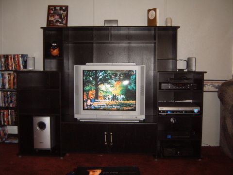 1988 Ford Bronco - A home entertainment center features a large television, surround sound system, and extensive media storage.