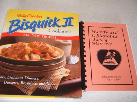 1988 Ford Bronco - Two cookbooks are displayed on a counter. One is a Betty Crocker Bisquick II Cookbook, and the other is a Woodward Oklahoma Tasty Morsels c…