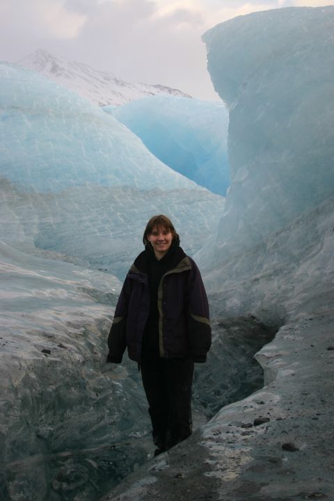 2003 Jeep TJ - A person stands on a glacier, surrounded by towering blue ice formations and distant snowy peaks.