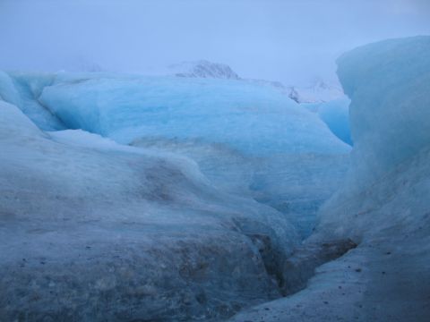 2003 Jeep TJ - Blue ice formations and crevasses on a glacier under a hazy sky.