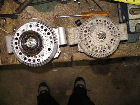 1995 Ford Bronco - Comparison of a new and an old alternator, likely for a vehicle repair or upgrade.