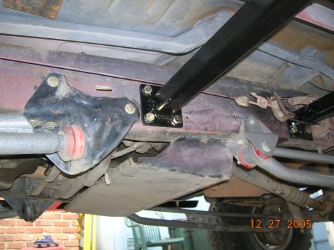 1985 Ford Bronco - Undercarriage view shows aftermarket suspension modifications and a date stamp of 12.27.2005.