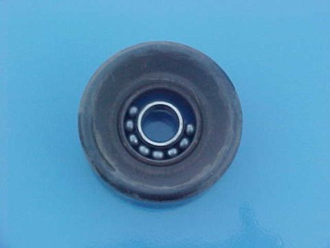 1994 Ford Crown Victoria - A close-up view of a vehicle idler pulley with a ball bearing inside.