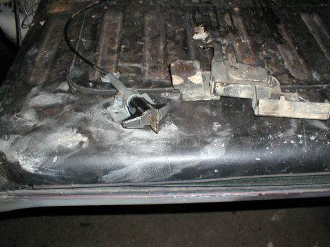 1979 Ford Bronco - Close-up of a tailgate latch mechanism, showing its internal components and cable attachment.