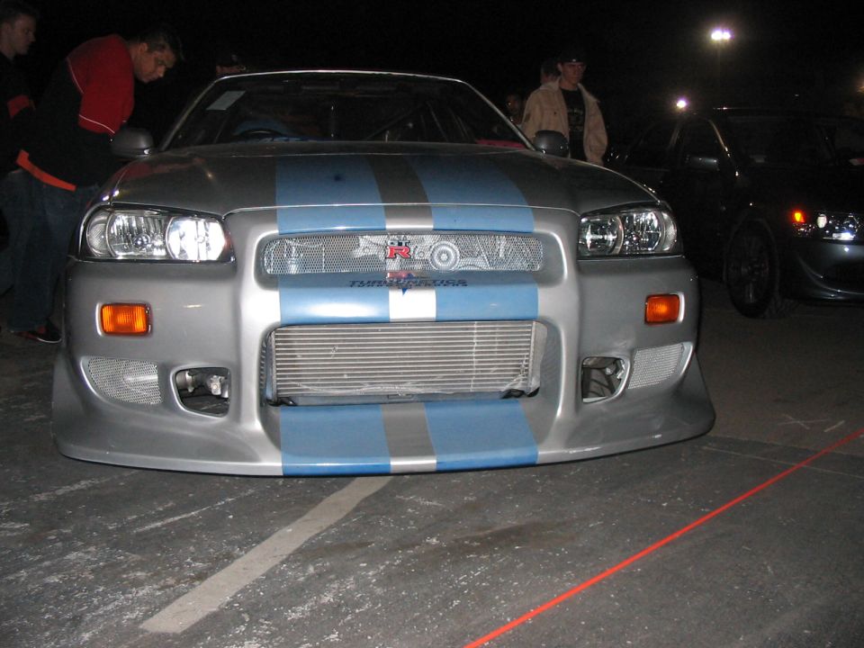 Silver Nissan Skyline GT-R with blue racing stripes and an intercooler